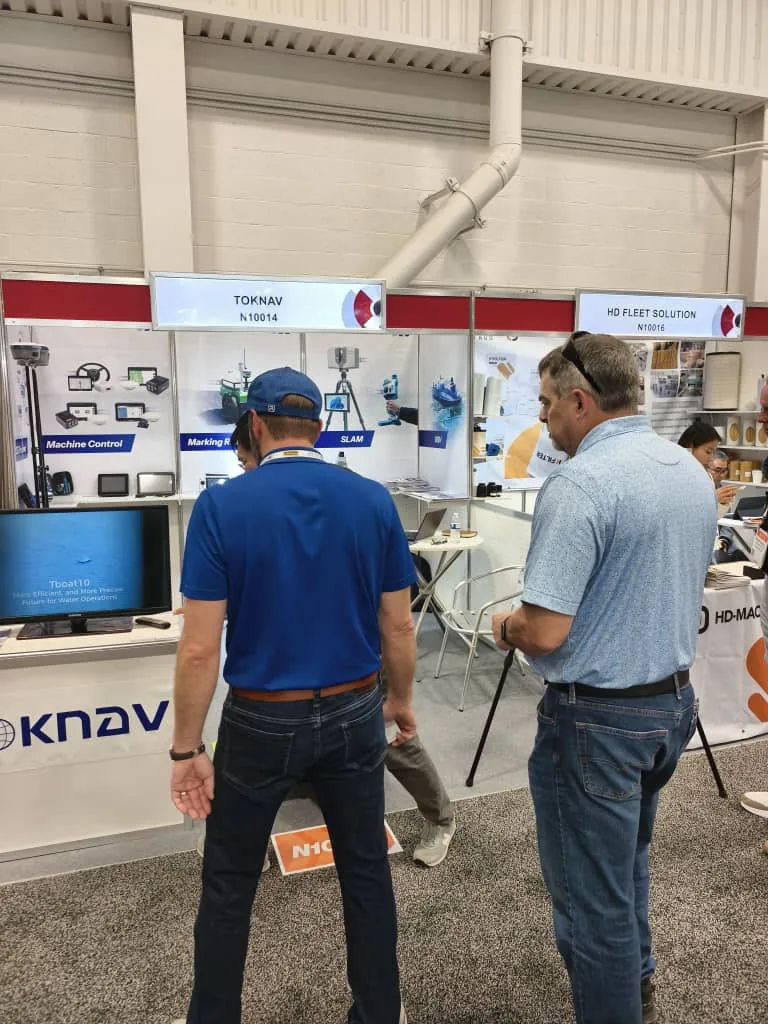 Overseas visitors reviewing TOKNAV products